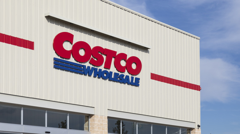 A Costco Wholesale storefront set against a blue sky