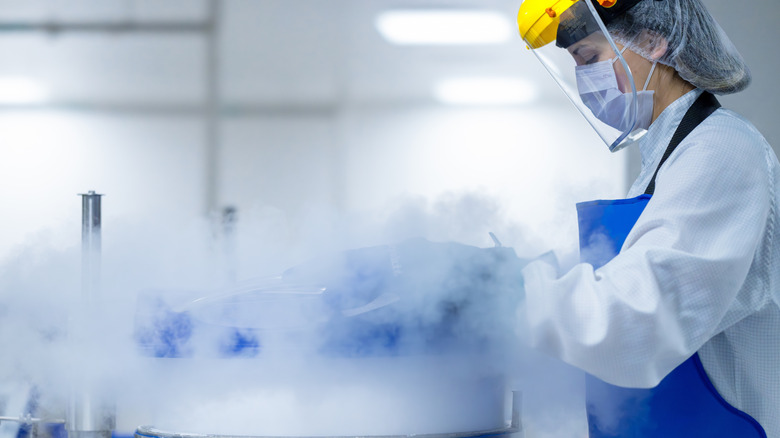 Scientist in lab handling cryogenic samples