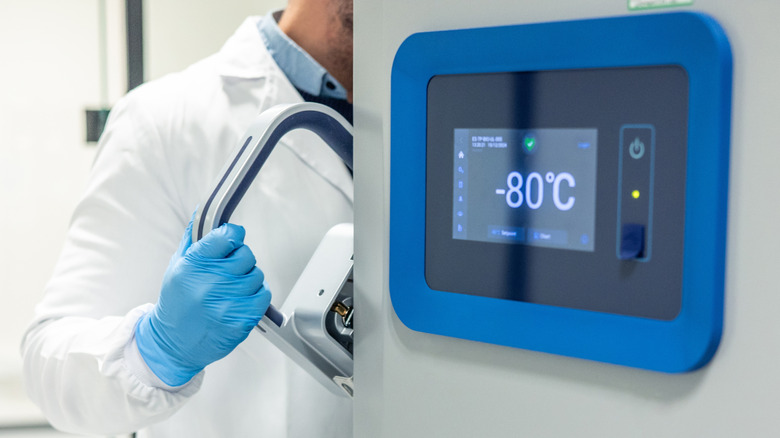 Scientist removing cryogenic samples from freezer