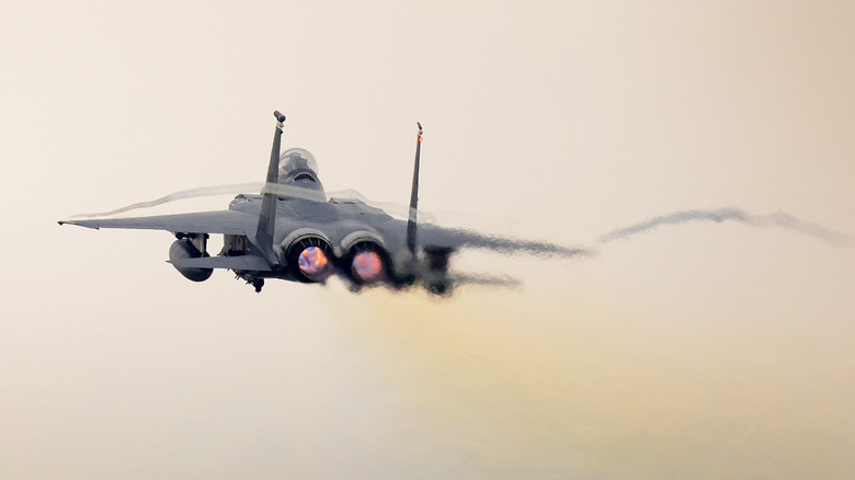 An F-15 Strike Eagle fighter jet soars through the air.