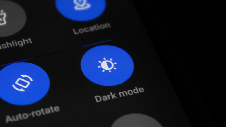 A phone showing a Dark Mode button in the control button