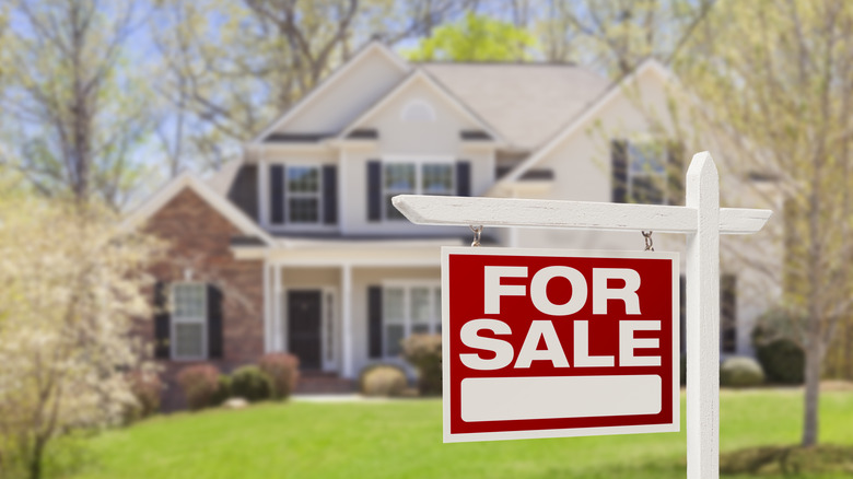 A home with a for sale sign outside of it