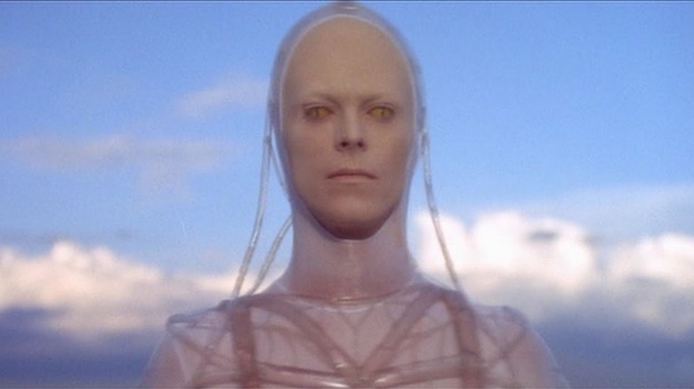 Thomas standing front of white clouds in "The Man Who Fell to Earth."