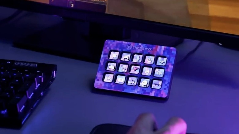Elgato Stream Deck with a custom skin and custom icons on a desk bathed in purple light.