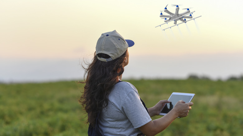 A person piloting a drone during takeoff