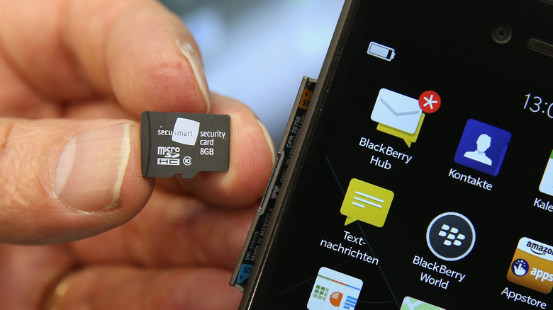 A microSD card being inserted into a phone