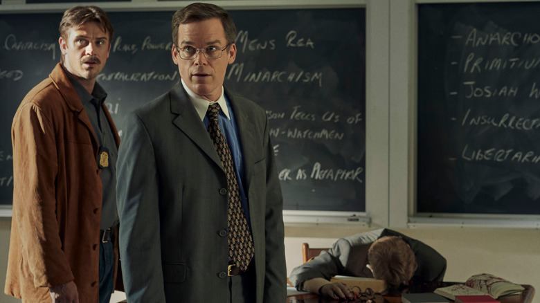 Lockhart and Holt looking surprised in a classroom