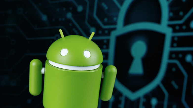 Android character mascot toy, with a security shield icon in the background.
