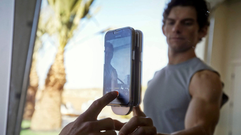 An iPhone mounted to a mirror using Flipstik