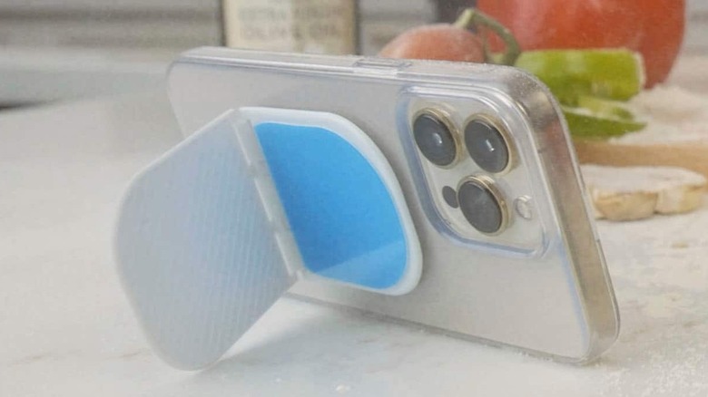 An iPhone placed on an kitchen island with Flipstik attached to the back