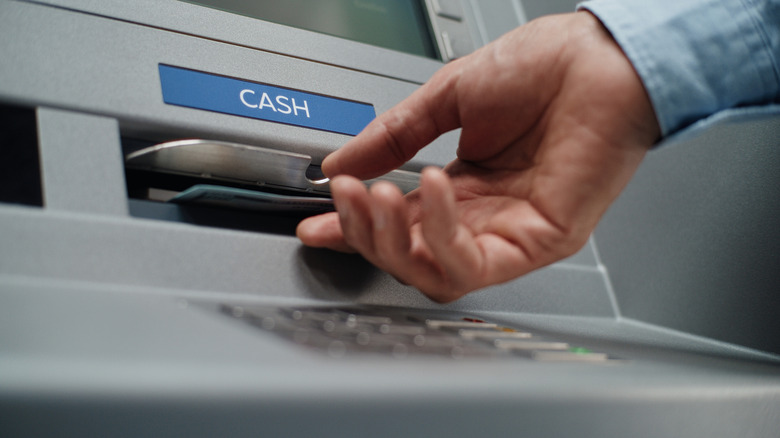 a person using an ATM