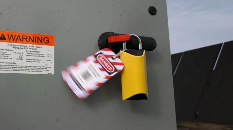 A BoxLock smart padlock with a lockout tag