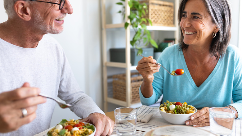 a senior couple enjoying a meal together at a table