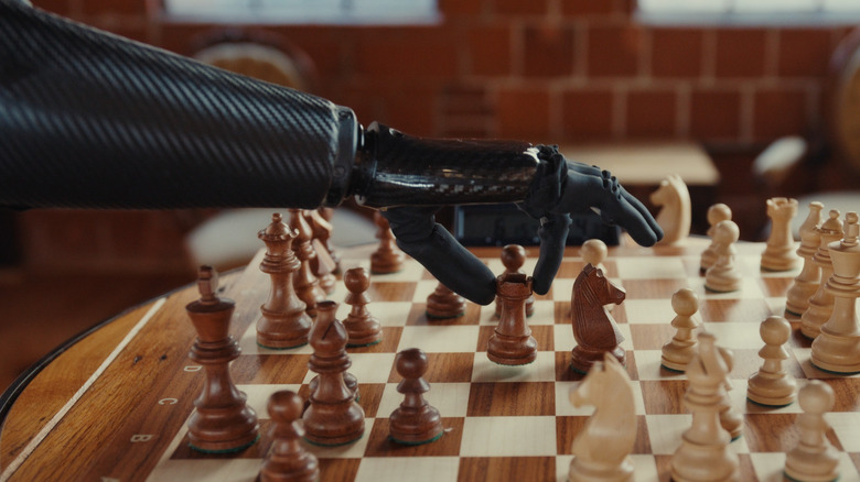 A person playing chess using a Psyonic Ability Hand