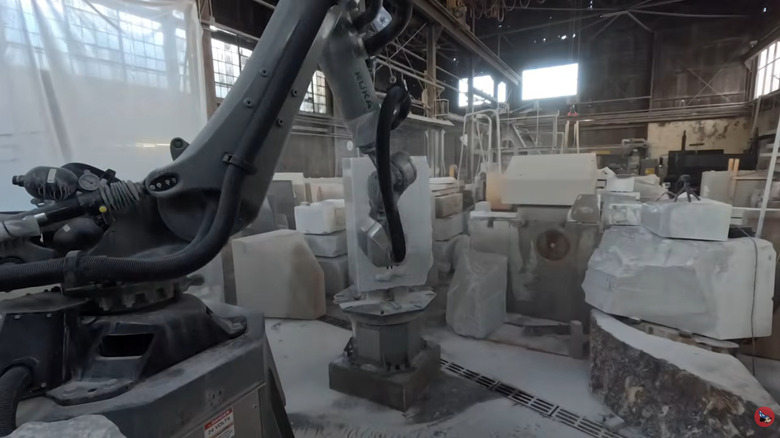 A robot arm carving a marble statue for Disney