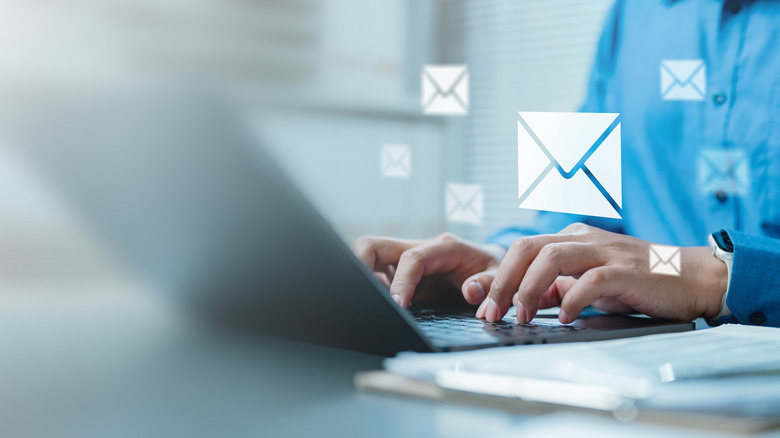 A concept of a person sending emails with a laptop.
