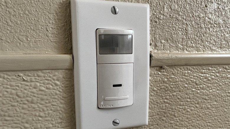 A motion sensor light switch on a wall.
