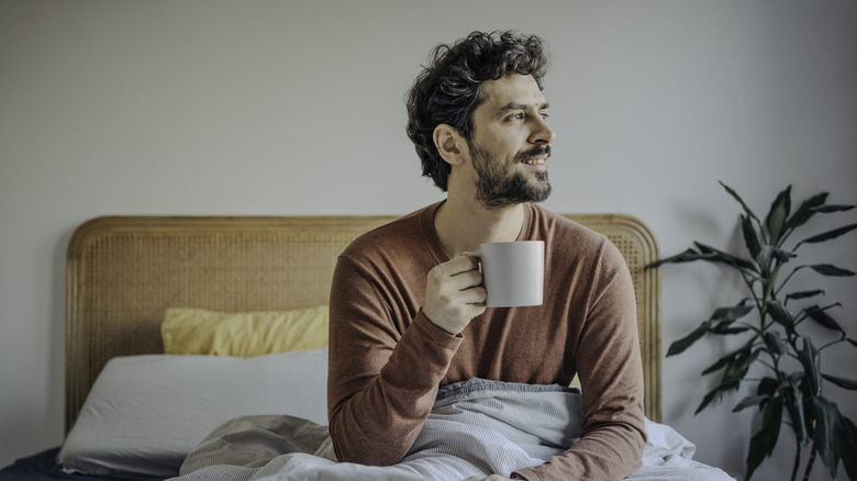 Person in bed with coffee mug