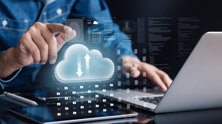 cloud storage solutions concept, hand hovering over fingerprint holographic with virtual cloud above a tablet