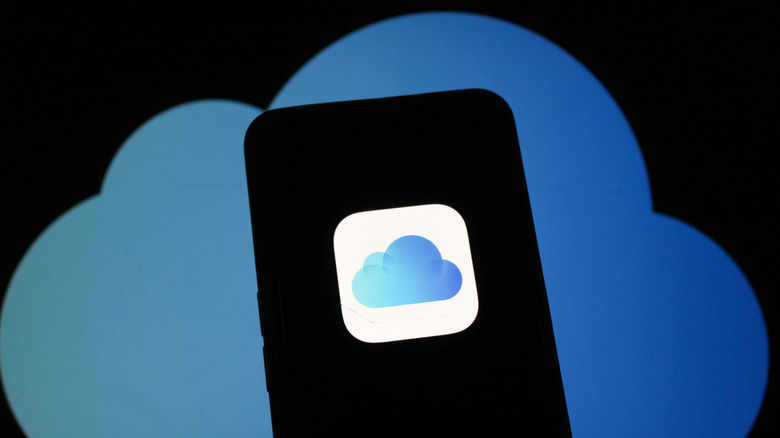 The iCloud logo on a smartphone with the same logo in the background