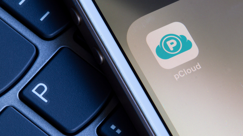 pCloud cloud storage app icon on a smartphone on top of a keyboard