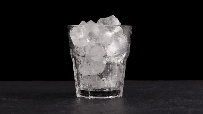 Ice cubes in a glass against a black background