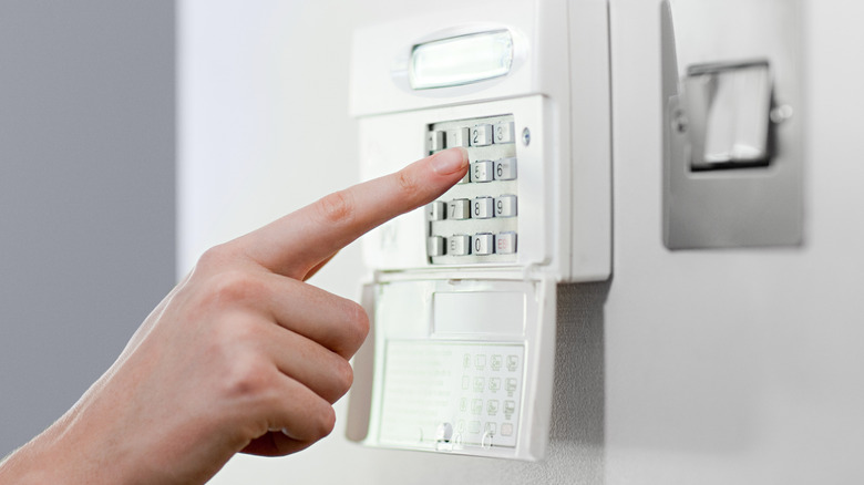 Person using a security system keypad