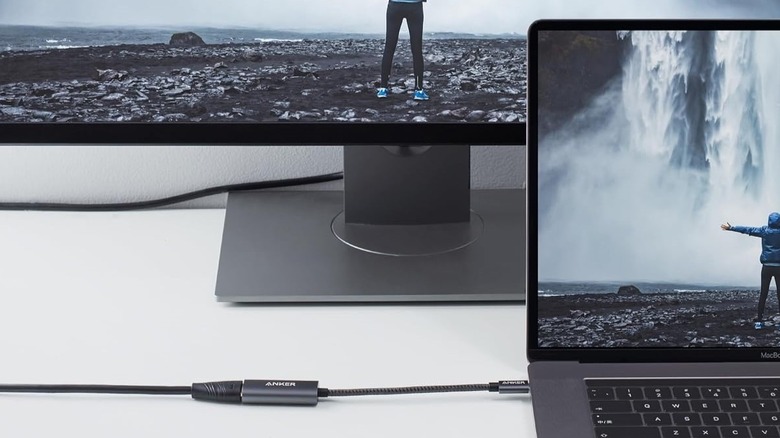An Anker USB-C to HDMI adapter plugged into a laptop and an external display.