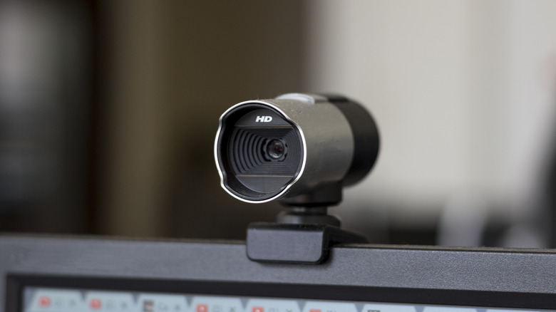 Webcam sitting on top of computer monitor