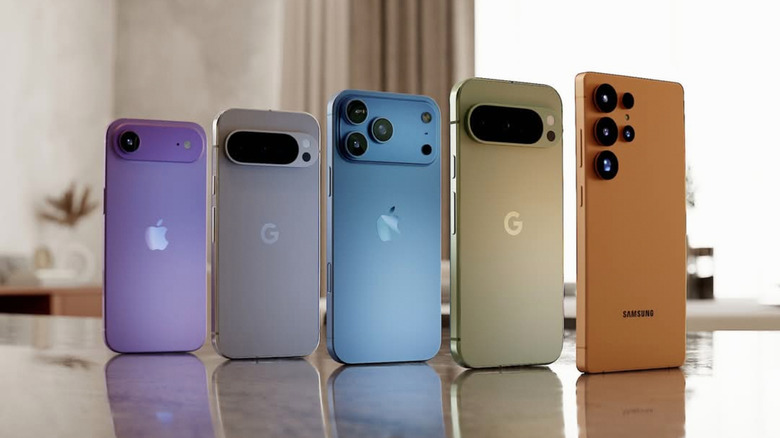 Various iPhone, Pixel, and Galaxy models lined up on a countertop in a sunlit room.