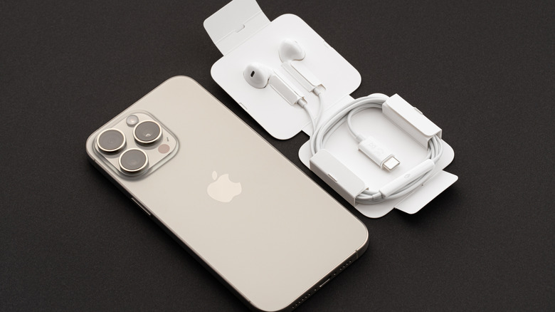 Apple EarPods headphones with an iPhone next to them