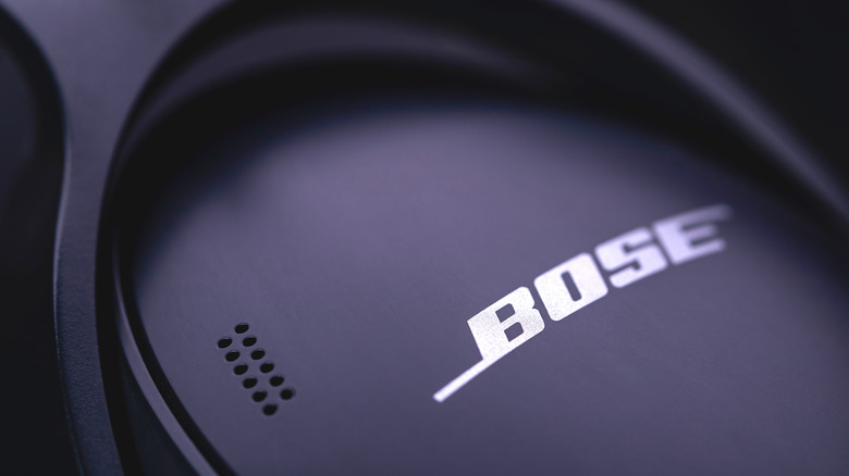 A close-up of Bose logo on a pair of headphones.