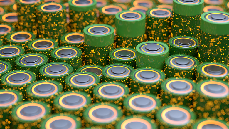 A selection of green batteries arranged in rows.