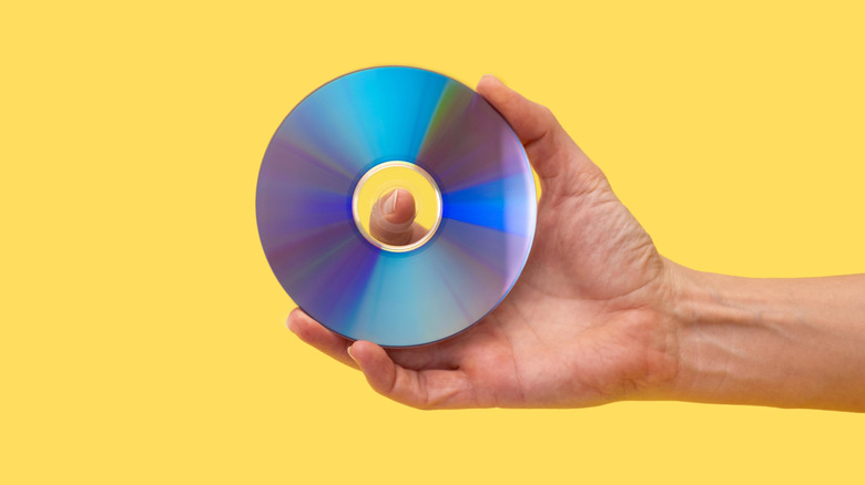 Someone holding a pristine-looking optical disc.
