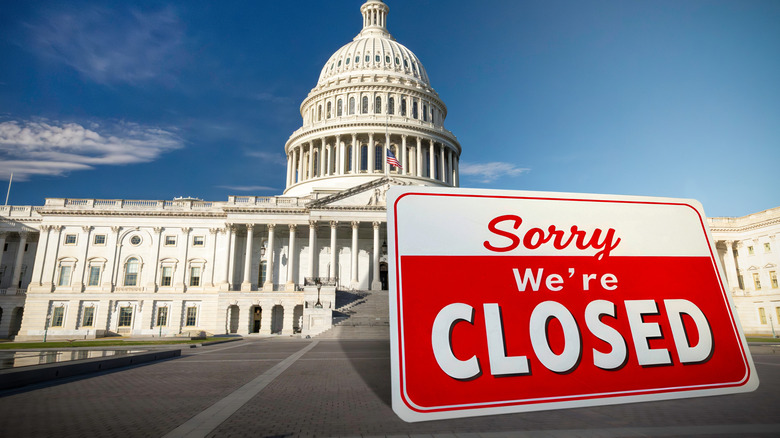 United States Capitol building with a sorry we're closed sign out front.