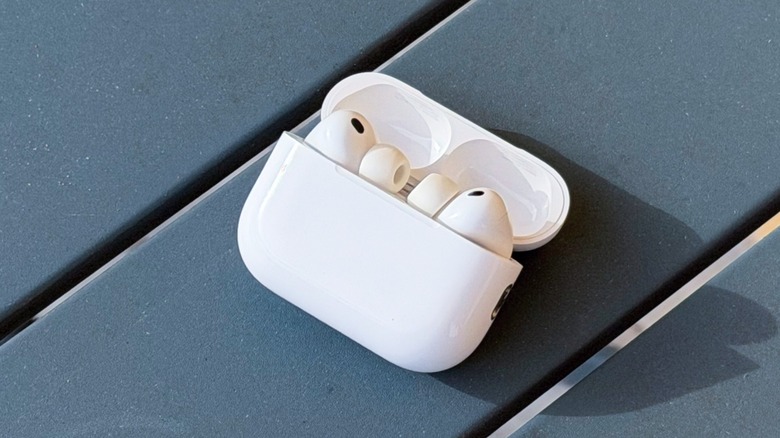 A close-up shot of the Apple AirPods Pro 3 on a gray table.