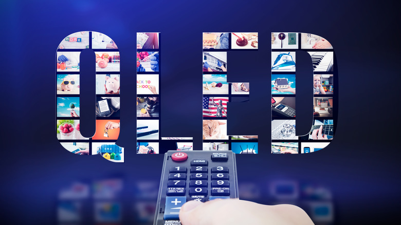 QLED in big letters made of screens with a hand holding a remote in front.