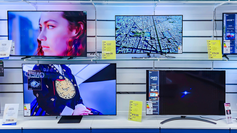 Smart TVs on display in an electronics store