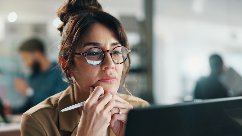 Professional thinking while looking at laptop screen