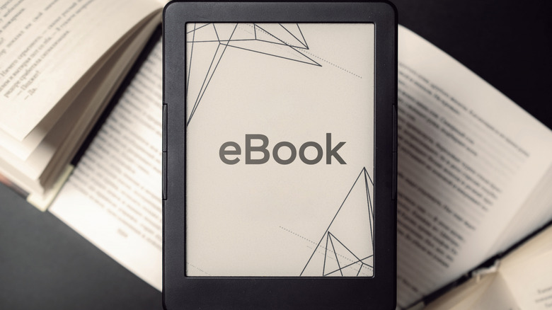 Kindle displaying "eBook" text placed over open physical books