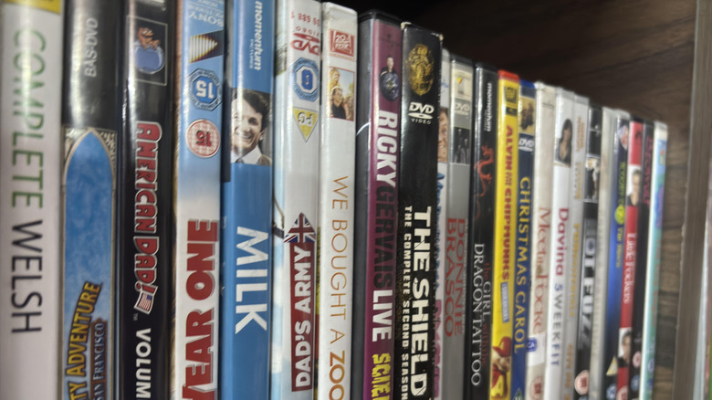 a row of physical movies on a shelf