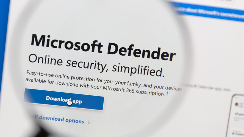 A magnifying glass examining the product description for Microsoft Defender.
