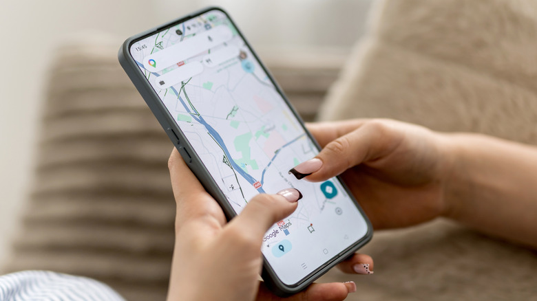 A Google Maps user pinches on their phone's screen to scroll and zoom.