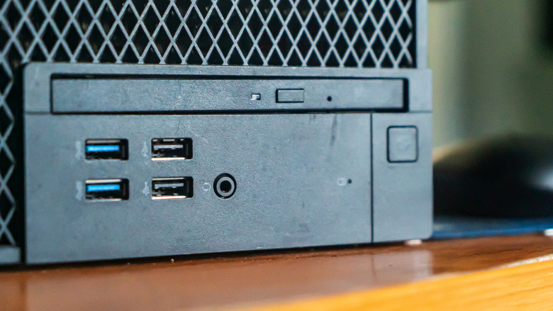 Desktop computer with blue USB ports next to black ones.