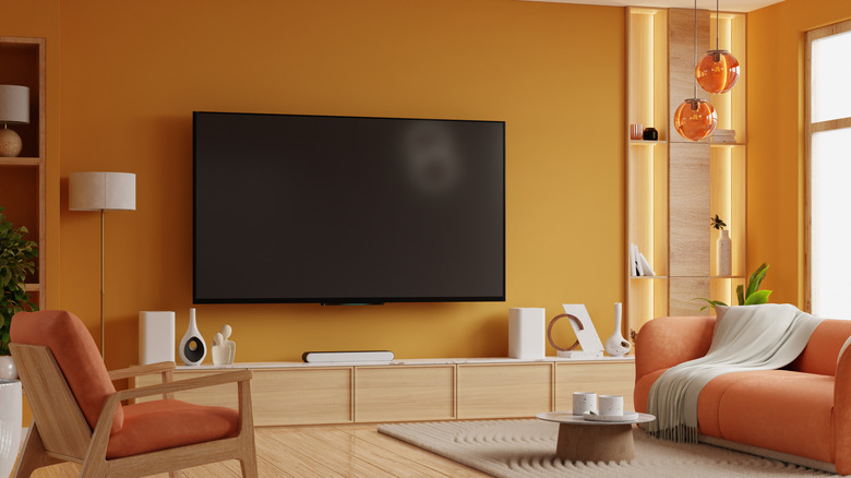 A cozy TV setup with orange-colored furniture