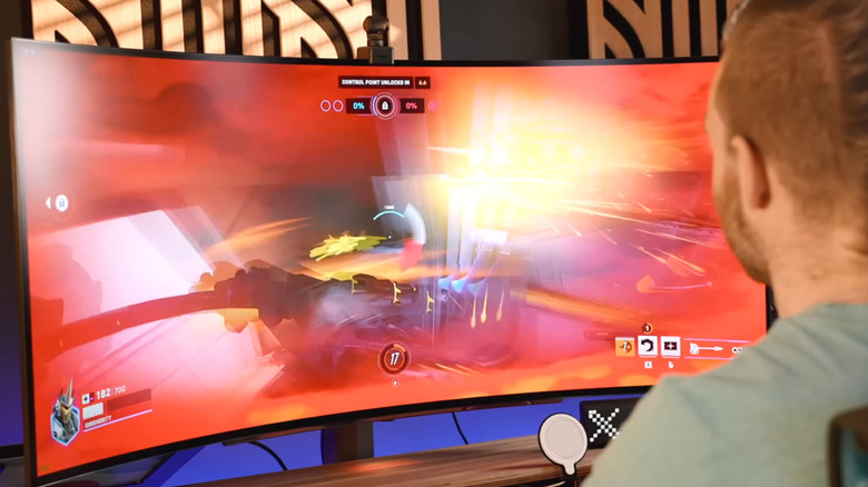 A game being played on an ultrawide curved LG OLED monitor