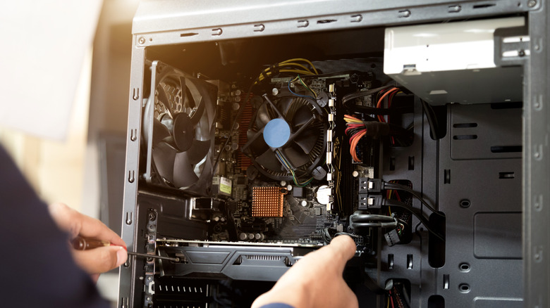 Person changing components in a desktop PC.