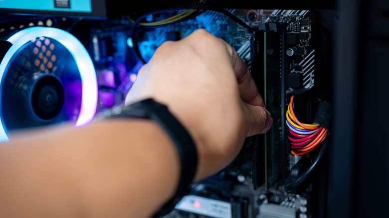 Person installing RAM in a desktop PC.