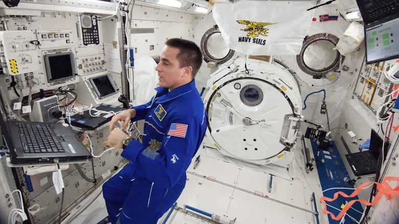 NASA astronaut Chris Cassidy using a ThinkPad laptop aboard the International Space Station in 2013.