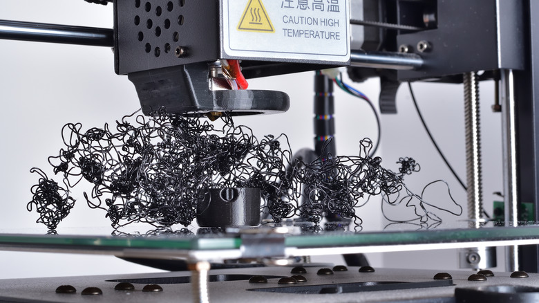 A failed 3D print, with a printing bed full of filament noodles.